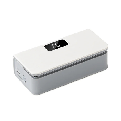 Portable bag sealer with white top, black control window, and rounded gray base